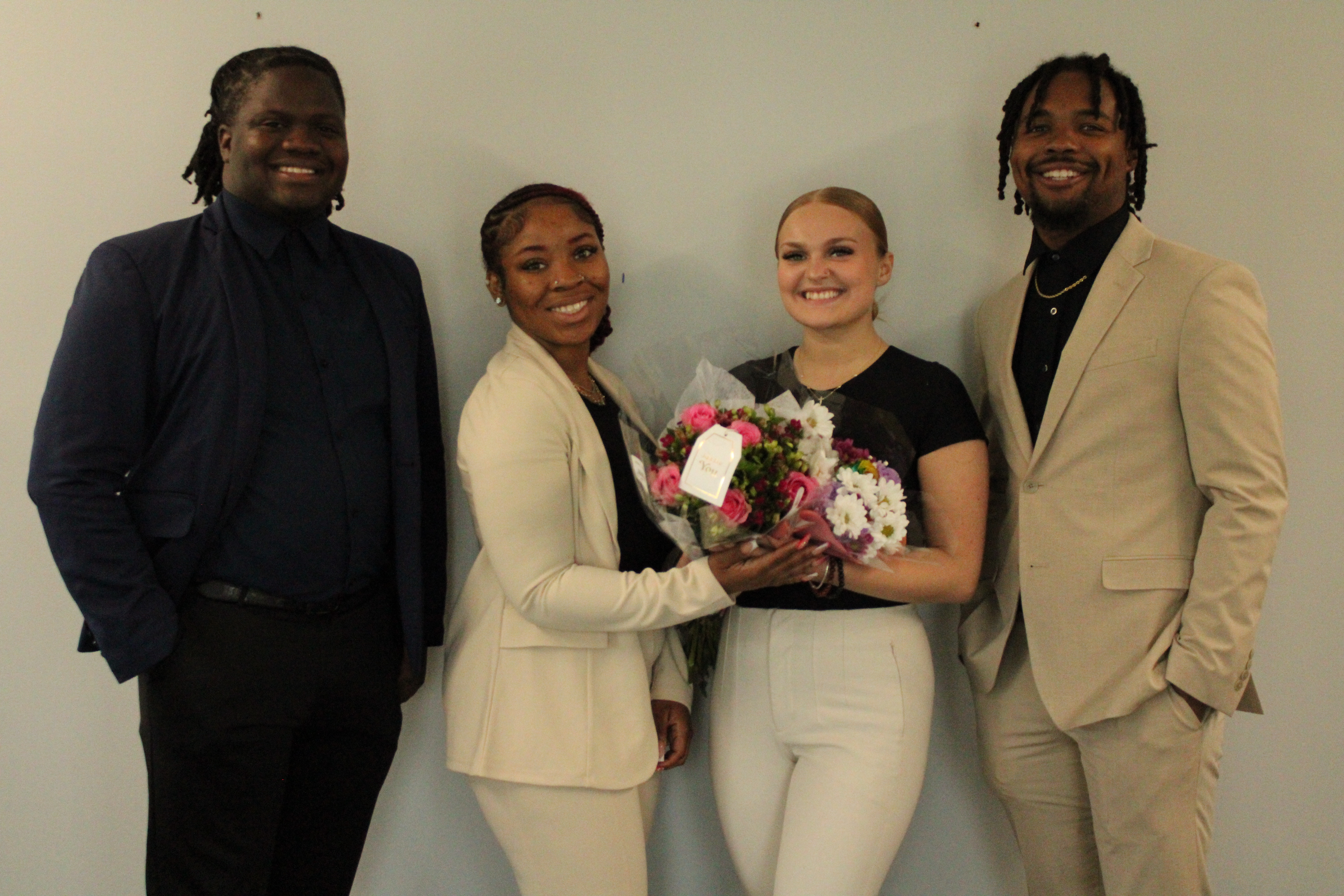 Ironwood West Michigan Group team members celebrating together with flowers